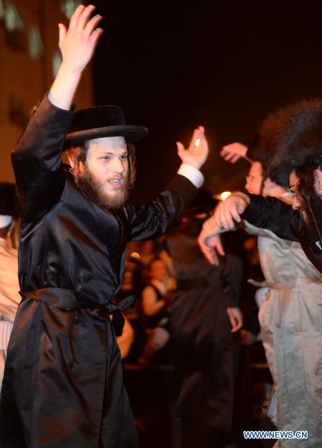 Ultra-Orthodox Jews dance around a Lag BaOmer bonfire in Jerusalem on late April 27, 2013, marking annual Jewish holiday Lag BaOmer which has been reinterpreted as a commemoration of the Bar Kokha revolt against the Roman Empire. (Xinhua/Yin Dongxun)