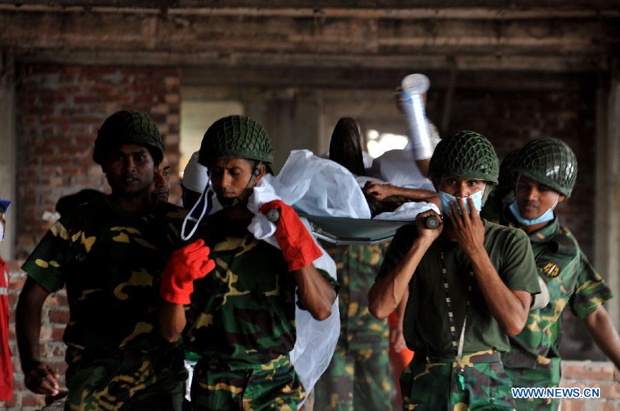 Rescuers carry a surviving garment worker out of the rubble at the collapsed Rana Plaza building in Savar on the outskirts of Dhaka, Bangladesh, April 27, 2013. In the wake of violent protests over Wednesday's building collapse that has left 332 workers dead so far, two of the owners of five ready-made garment factories housed in the collapsed Bangladesh building were arrested early Saturday. (Xinhua/Shariful Islam)