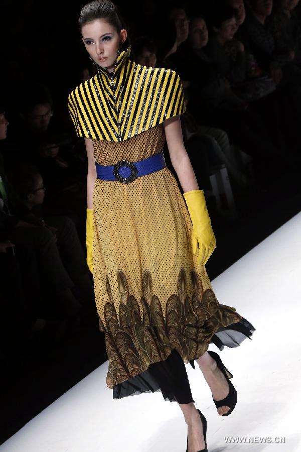 A model presents a creation designed by graduates from the College of Art and Design of Wuhan Textile University during the China Graduate Fashion Week in Beijing, capital of China, April 27, 2013. (Xinhua/Li Mingfang) 