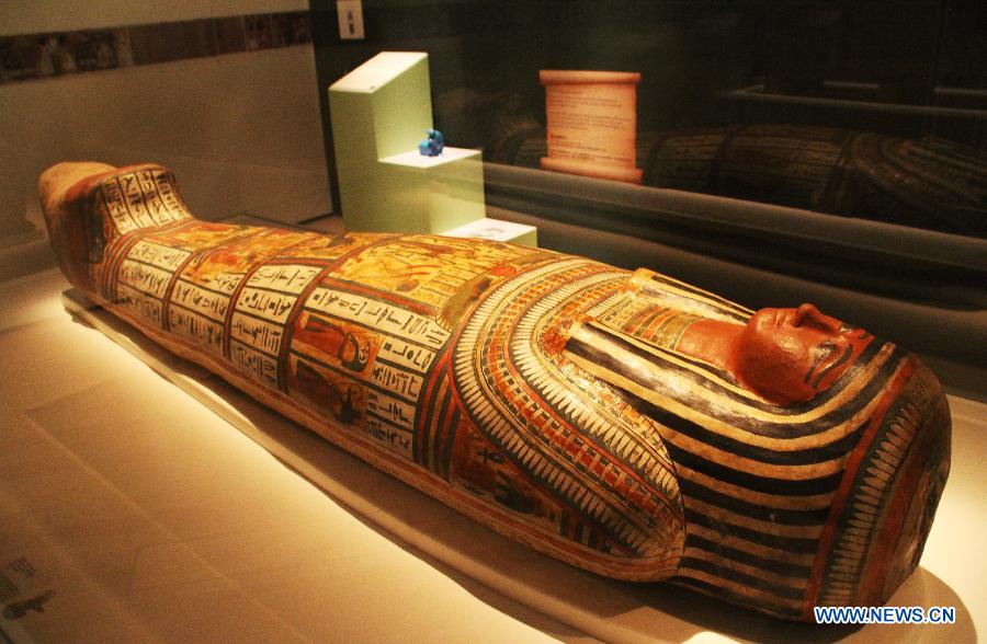 Photo taken on April 27, 2013 shows a human mummy at Singapore's Marina Bay Sands ArtScience Museum in Singapore. An exhibition named "Mummy: Secrets of the Tomb" opened to the public on Saturday, showing 100 artifacts and six mummies from the ancient Egyptian collection of the British Museum. (Xinhua/Hu Juanxin) 