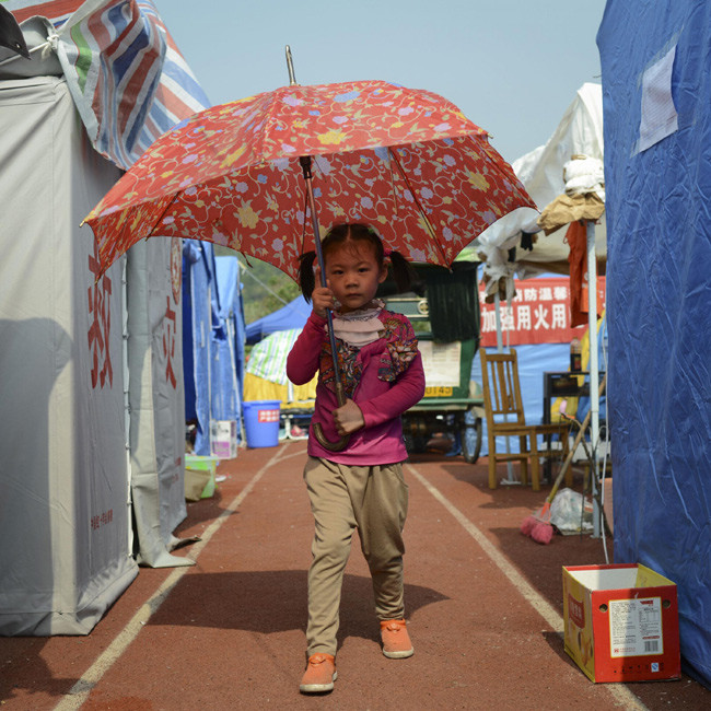 Mao Tianai, 4, is seen in a resettlement site for earthquake victims in Lushan county, Southwest China's Sichuan province. Photo taken on April 26. [Photo/Xinhua]