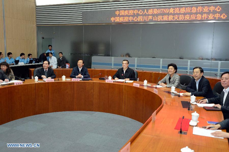 Chinese Premier Li Keqiang (C) attends a video meeting on the prevention and control of H7N9 virus in east China's Zhejiang Province and epidemic prevention after the Lushan Earthquake in southwest China's Sichuan Province, during his visit to the Chinese Center for Disease Control and Prevention (CDC), in Beijing, capital of China, April 28, 2013. Li urged authorities to be vigilant against the H7N9 avian flu virus and prepare themselves for any new developments. (Xinhua/Li Tao)