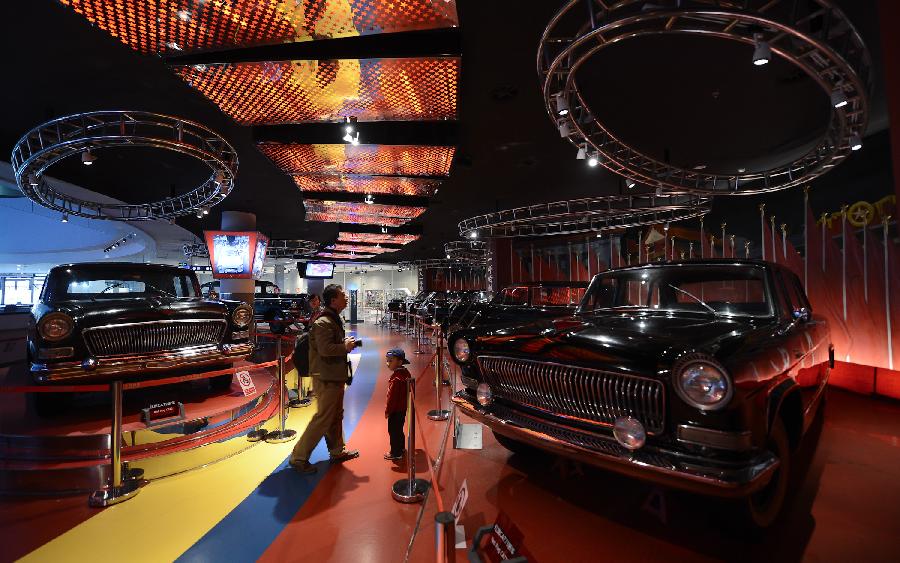 Visitors watch cars displayed in the Beijing Auto Museum in Beijing, capital of China. Beijing Auto Museum, a museum aimed at the promotion of auto culture, was awarded the National 4A tourist attraction on Sunday. (Xinhua/Qi Heng)