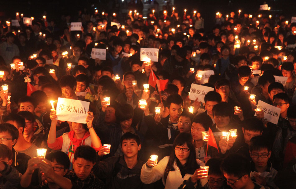 Students at University of South China gather in a square to pray for quake victims in southwest China’s Sichuan province by lighting candles, April 24, 2013. (Xinhua/Cao Zhengping)