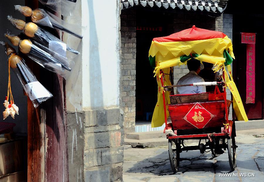 A pedicab runs on a lane in Sanhe Town of Feixi County, east China's Anhui Province, April 25, 2013. The Sanhe Ancient Town, which has a history of more than 2,500 years, is a typical "ancient town full of rivers and lakes, together with small bridges, flowing water and local dwellings." (Xinhua/Wang Song)