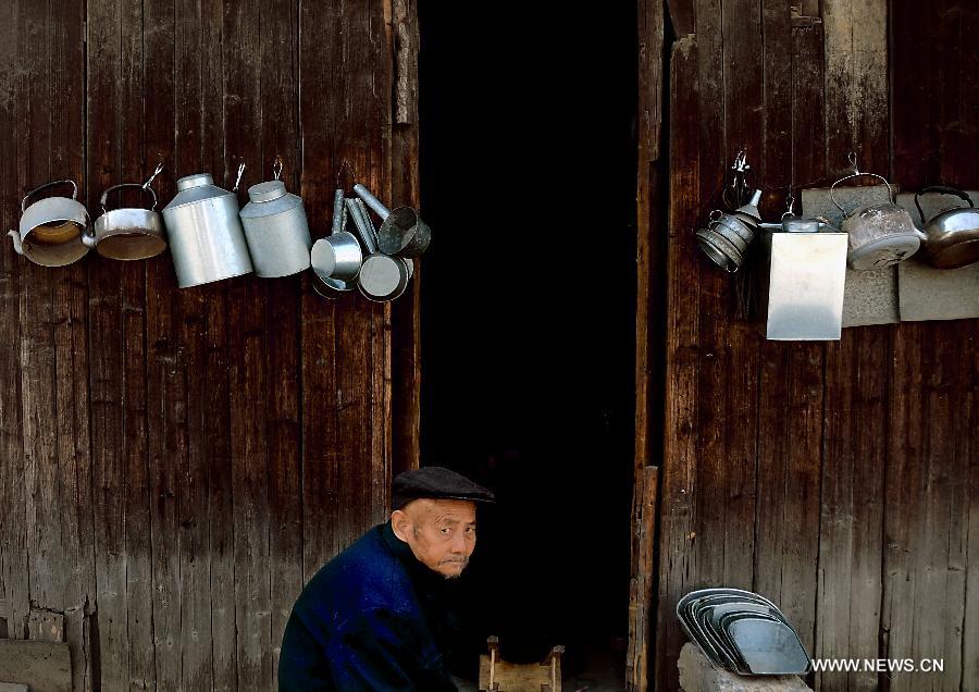 A blacksmith wait for customers in front of his shop in Sanhe Town of Feixi County, east China's Anhui Province, April 25, 2013. The Sanhe Ancient Town, which has a history of more than 2,500 years, is a typical "ancient town full of rivers and lakes, together with small bridges, flowing water and local dwellings." (Xinhua/Wang Song)