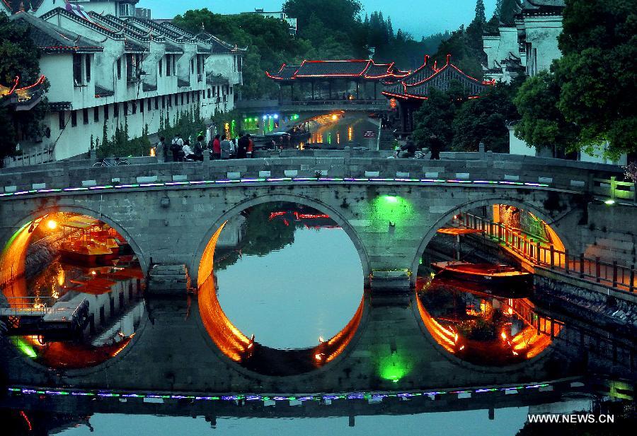 Photo taken on April 24, 2013 shows the night view of a bridge in Sanhe Town of Feixi County, east China's Anhui Province, April 24, 2013. The Sanhe Ancient Town, which has a history of more than 2,500 years, is a typical "ancient town full of rivers and lakes, together with small bridges, flowing water and local dwellings." (Xinhua/Wang Song)