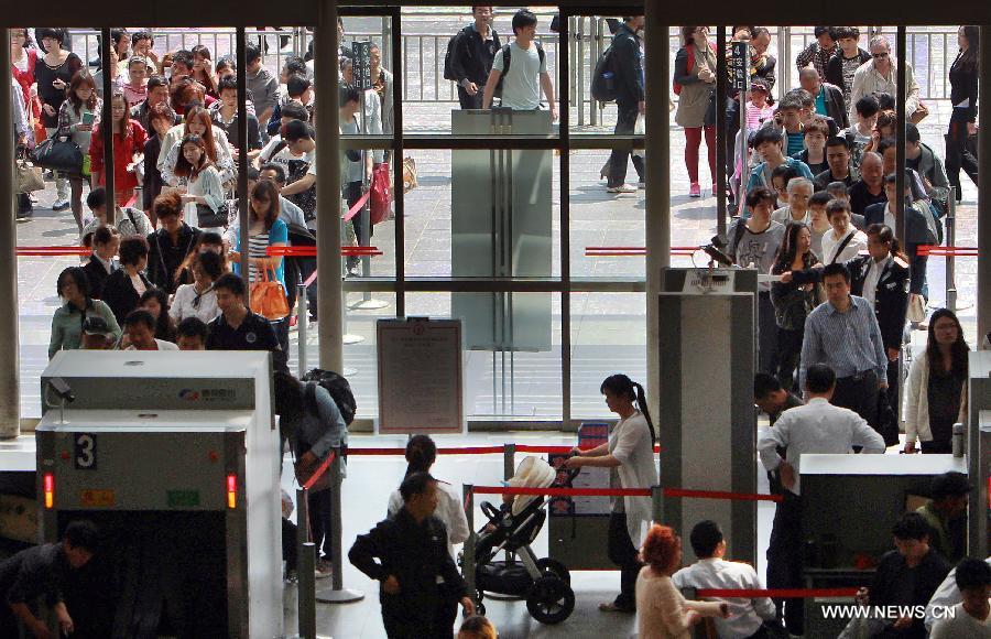 Passengers line up as they wait to enter Shanghai Railway Station in Shanghai, east China, April 28, 2013. China sees a travel rush around the country as the three-day May First national holiday comes around the corner. (Xinhua/Ding Ting)