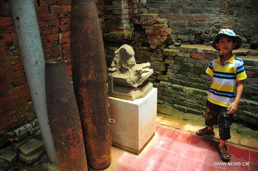 Bombs are seen in My Son Sanctuary, which was badly wrecked during last century's Vietnam War, in central Vietnam, on April 29, 2013. Between the 4th and 13th centuries, a unique culture which owed its spiritual origins to Indian Hinduism developed on the coast of contemporary Vietnam. It was graphically illustrated by the remains of a series of impressive tower-temples located in My Son that was the religious and political capital of the Champa Kingdom for most of its existence. My Son Sanctuary was inscripted in UNESCO's World Cultural Heritage list in 1999. (Xinhua/Zhang Jianhua) 