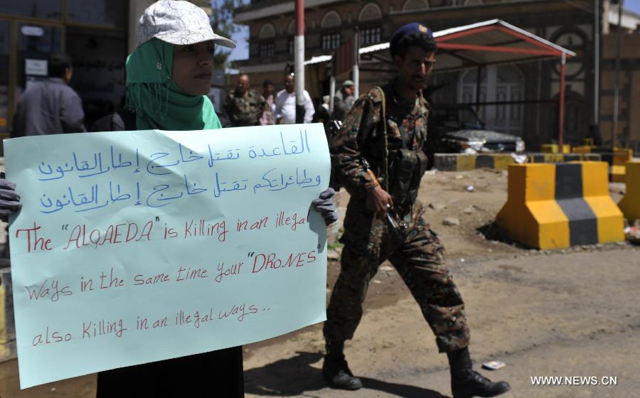 A Yemeni protester holds a banner that shows civilians killed by U.S. drones during a rally outside the U.S. embassy in Sanaa against drone strikes in Yemen, on April 29, 2013. Yemeni activists staged a rally on Monday to denounce U.S. drone strikes in Yemen. The U.S. has stepped up drone attacks against al-Qaeda militants in Yemen's southern regions this year which killed dozens of civilians and sparked mass protests. (Xinhua/Mohammed Mohammed)  