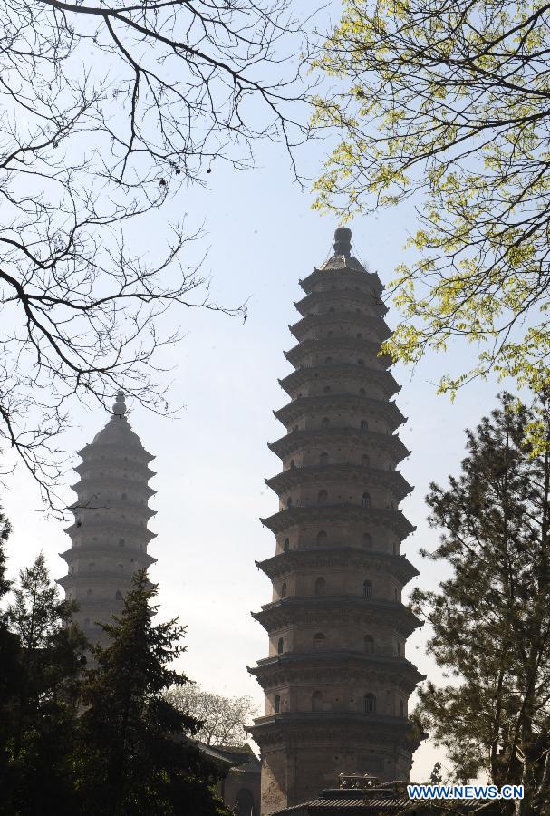 Twin pagodas are pictured at the Yongzuo Temple in Taiyuan, capital of north China's Shanxi Province, April 24, 2013. The well preserved pagodas, namely Wenfeng Pagoda and Xuanwen Pagoda, have a history of 400 years. With the height exceeding 54 meters, the pagodas overlook the city's existing ancient architectures and have been dubbed as the cultural landmark of Taiyuan. (Xinhua/Yan Yan)