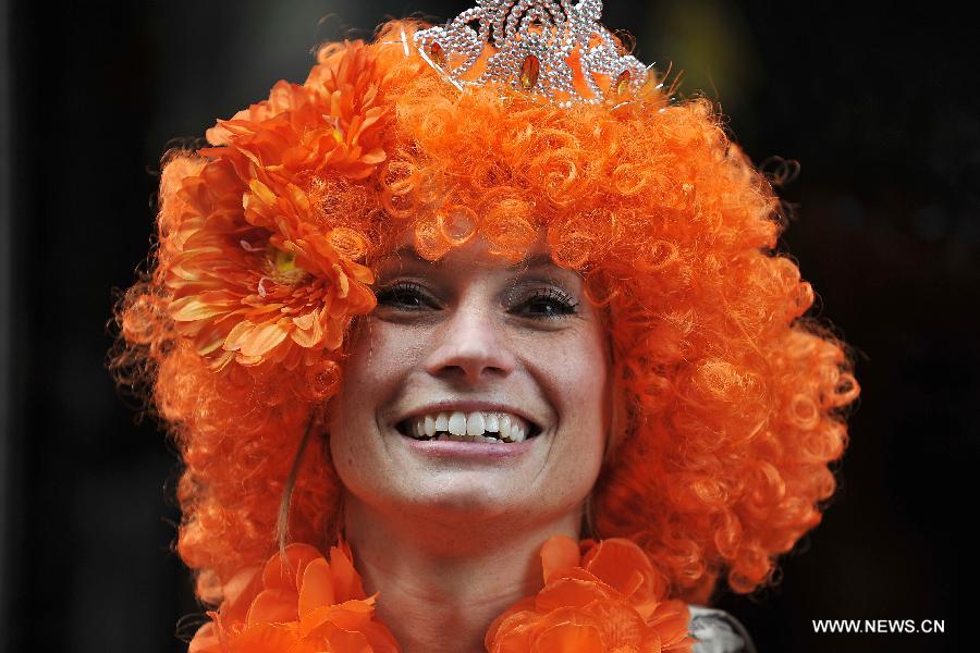 A woman joins the celebration of the inauguration of the new King of the Netherlands Willem-Alexander in Amsterdam, the Netherlands, April 30, 2013. Following the abdication of Queen Beatrix, the new King of the Netherlands Willem-Alexander was officially inaugurated on Tuesday. (Xinhua/Ye Pingfan)