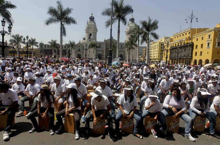 Participants play their cajons, a popular Peruvian instrument, during the International Festival of the Peruvian Cajon at Lima's Plaza Mayor, April 13, 2013. Almost 1,500 people took part in the event, playing the percussion instrument simultaneously, hoping to achieve a new world record for the world biggest cajon performance, according to organizers. (Xinhua/Reuters Photo)