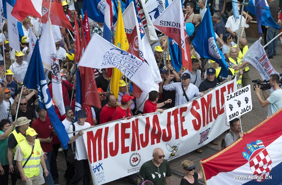 People attend the Labour Day rally in Zagreb, capital of Croatia, May 1, 2013. Thousands of Croatian workers celebrated the International Labour Day marching through the capital, demanding for more jobs, better work conditions and higher wages. (Xinhua/Miso Lisanin)