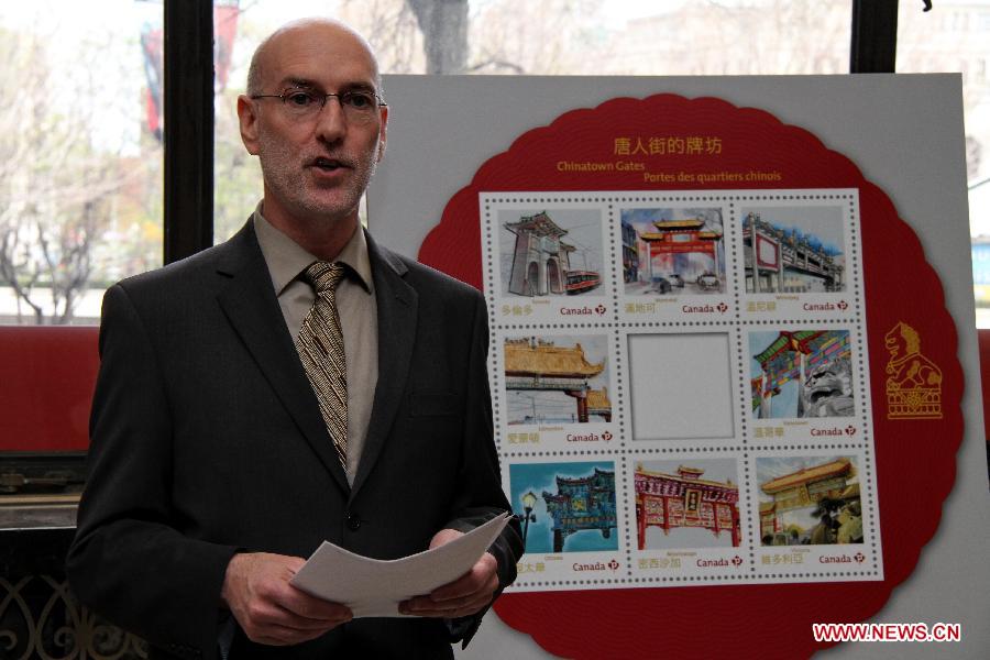 Spokesman of Canada Post Jim Philips speaks at the ceremony launching the Chinatown Gates stamps in Ottawa, Canada, May 1, 2013. Canada Post launched a special series of stamps featuring Chinatown gates located in eight cities across the country on Wednesday to highlight the longstanding heritages of Chinese-Canadians. (Xinhua/Zhang Dacheng)