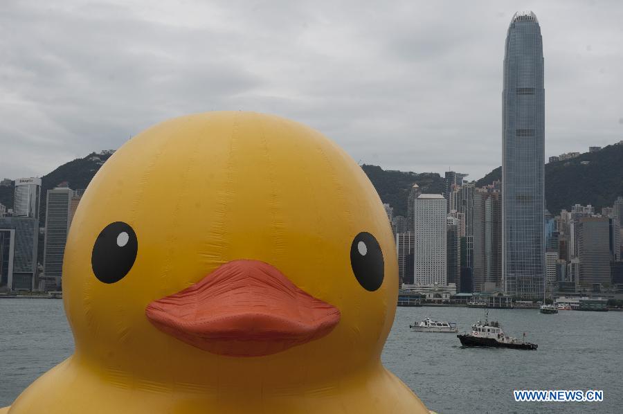 A huge rubber duck floats on the waters at the Victoria Harbor in Hong Kong, south China, May 2, 2013. The largest rubber duck was created by Dutch artist Florentijn Hofman, with 18 meters of length, 15 meters of width and height. The duck has visited 12 cities since 2007. (Xinhua/Lui Siu Wai) 
