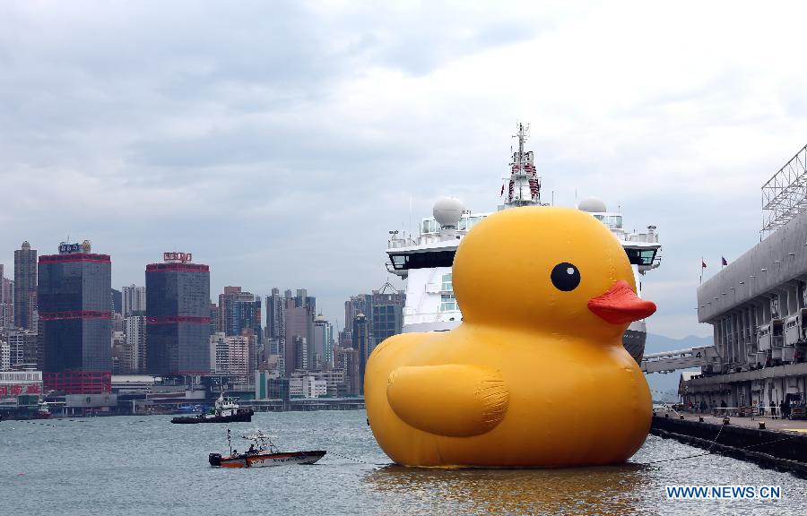 A huge rubber duck floats on the waters at the Victoria Harbor in Hong Kong, south China, May 2, 2013. The largest rubber duck was created by Dutch artist Florentijn Hofman, with 18 meters of length, 15 meters of width and height. The duck has visited 12 cities since 2007. (Xinhua/Li Peng)