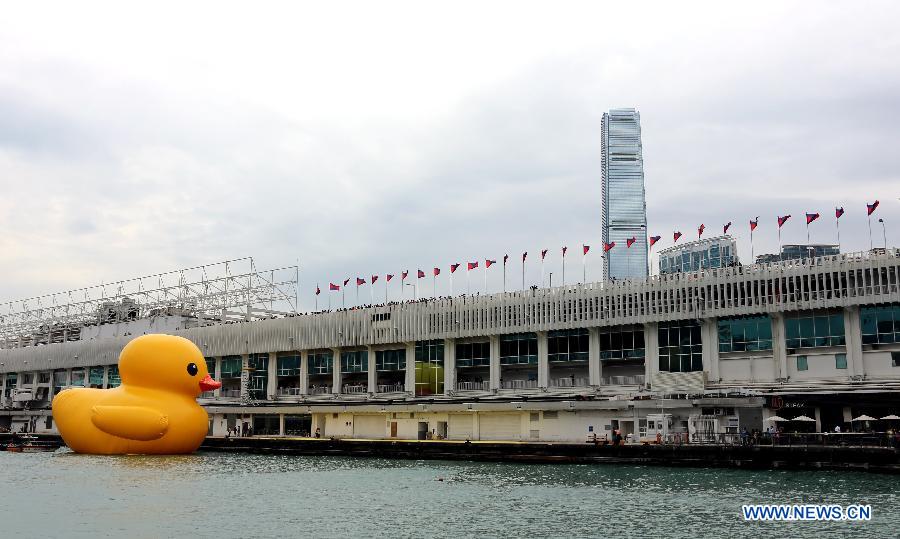 A huge rubber duck floats on the waters at the Victoria Harbor in Hong Kong, south China, May 2, 2013. The largest rubber duck was created by Dutch artist Florentijn Hofman, with 18 meters of length, 15 meters of width and height. The duck has visited 12 cities since 2007. (Xinhua/Li Peng)
