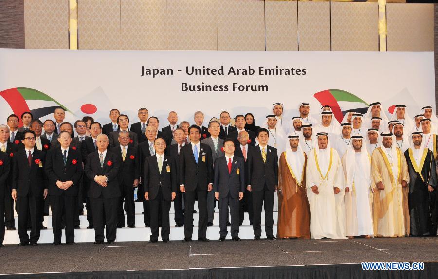 Japanese Prime Minister Abe Shinzo (6th R, first row) poses for photos with delegates of governments and business circles from Japan and Unites Arab Emirates as he attends the opening ceremony of the Japan-United Arab Emirates Business Forum in Abu Dhabi, the United Arab Emirates, on May 2, 2013. (Xinhua/Ma Xiping)