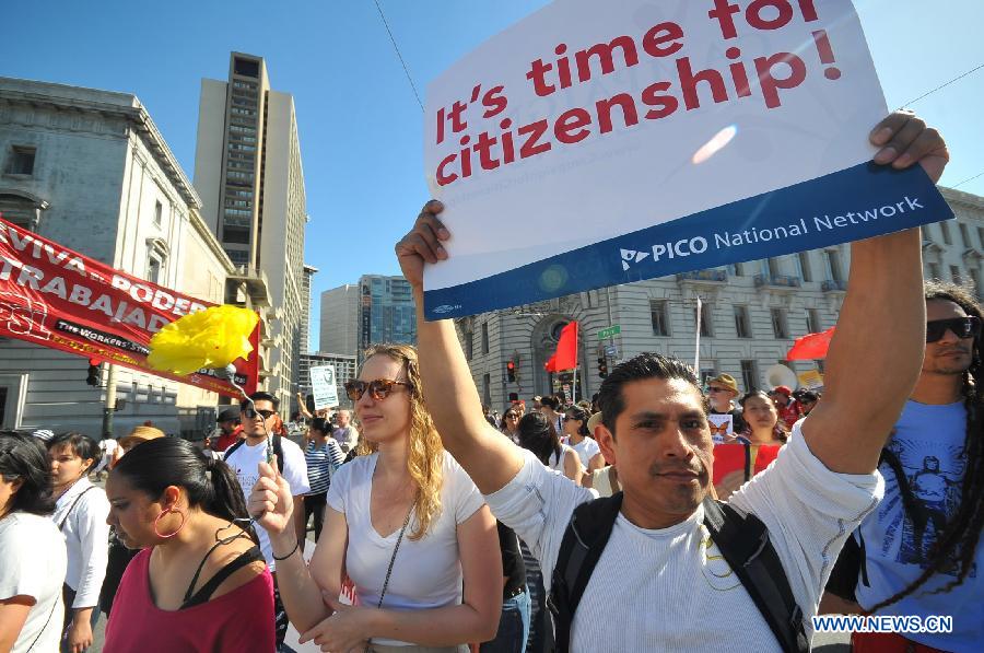 People attend a rally to urge a reform of immigration policy in San Francisco, California, the United States, on May 1, 2013. People attended the rally held by labour unions and labour rights protection institutions to urge the U.S. congress to legalize the immigration reform as soon as possible on Wednesday. New York, San Francisco, Chicago and Philadelphia held rallies with similar themes on the same day. (Xinhua/Liu Yilin)