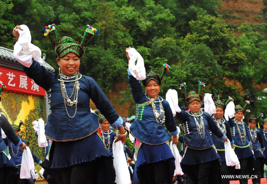Women of Zhuang ethnic group perform during the traditional "Huajie Festival" of Zhuang ethnic group, in Guangnan County, southwest China's Yunnan Province, May 2, 2013. (Xinhua/Chen Haining)
