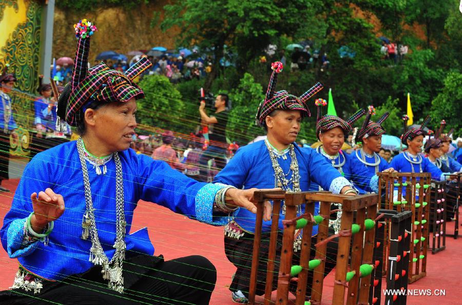 People of Zhuang ethnic group perform during the traditional "Huajie Festival" of Zhuang ethnic group, in Guangnan County, southwest China's Yunnan Province, May 2, 2013. (Xinhua/Chen Haining)