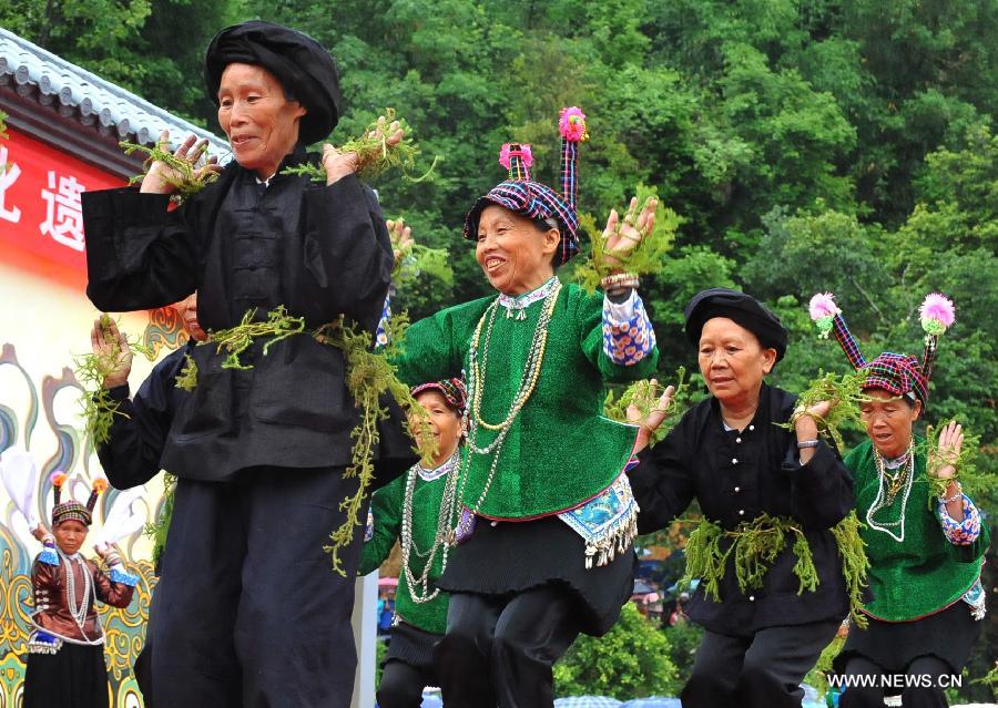 Women of Zhuang ethnic group perform during the traditional "Huajie Festival" of Zhuang ethnic group, in Guangnan County, southwest China's Yunnan Province, May 2, 2013. (Xinhua/Chen Haining)