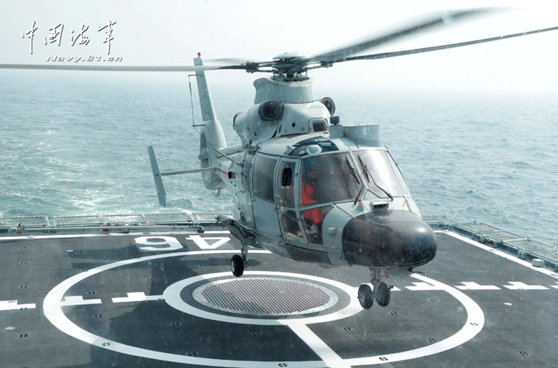 A ship-borne helicopter is in anti-submarine drills in the Yellow Sea under complicated weather conditions. (China Military Online)