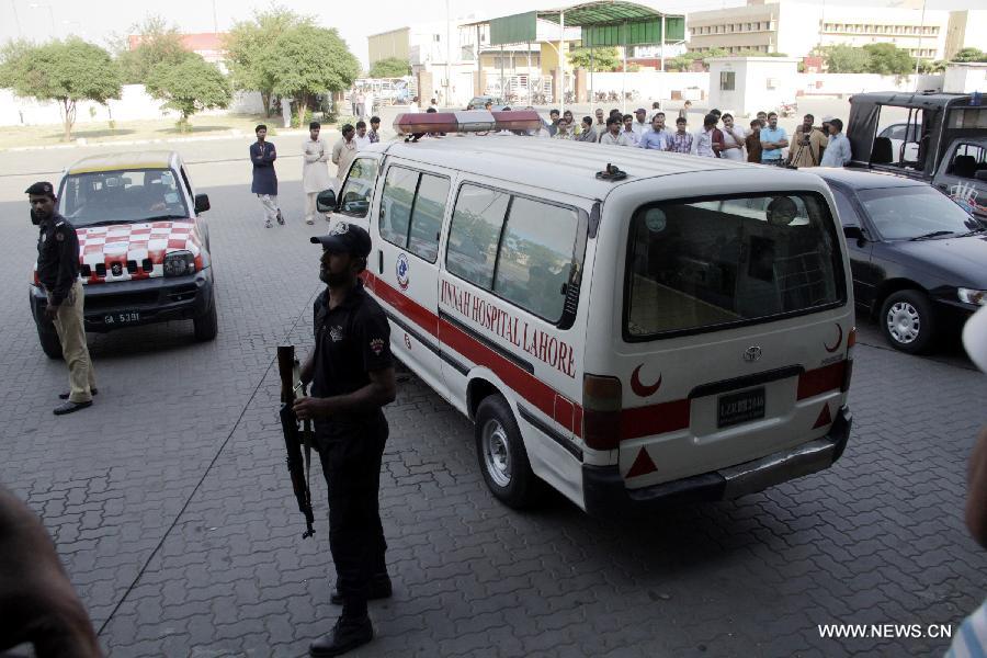 Pakistani policemen stand guard around an ambulance carrying the body of Sarabjit Singh, the Indian prisoner who was injured in an attack inside jail last week and died of wounds early Thursday. Singh spent more than 21 years in Pakistan after being convicted of spying for India and involvement in a series of bomb blasts in 1990 in which 14 people were killed. (Xinhua/Jamil Ahmed)