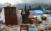 Family photos taken in front of dismantled houses
