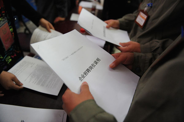 Prisoners participate in job fairs holding with recruitment job description of social enterprises in Beijing, on May 2, 2013. [Photo/Xinhua]
