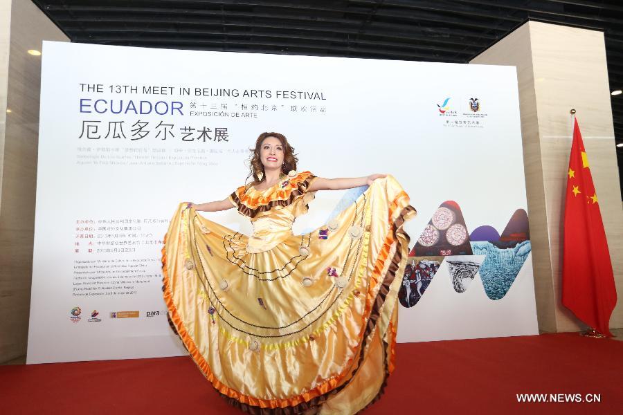 An actress presents Ecuadorian folk costumes at the Ecuador Art Exposition, an event of the 13th Meet in Beijing Arts Festival in Beijing, capital of China, May 3, 2013. A total of 83 works will be displayed at the exposition that kicked off on Friday. (Xinhua/Pan Siwei)
