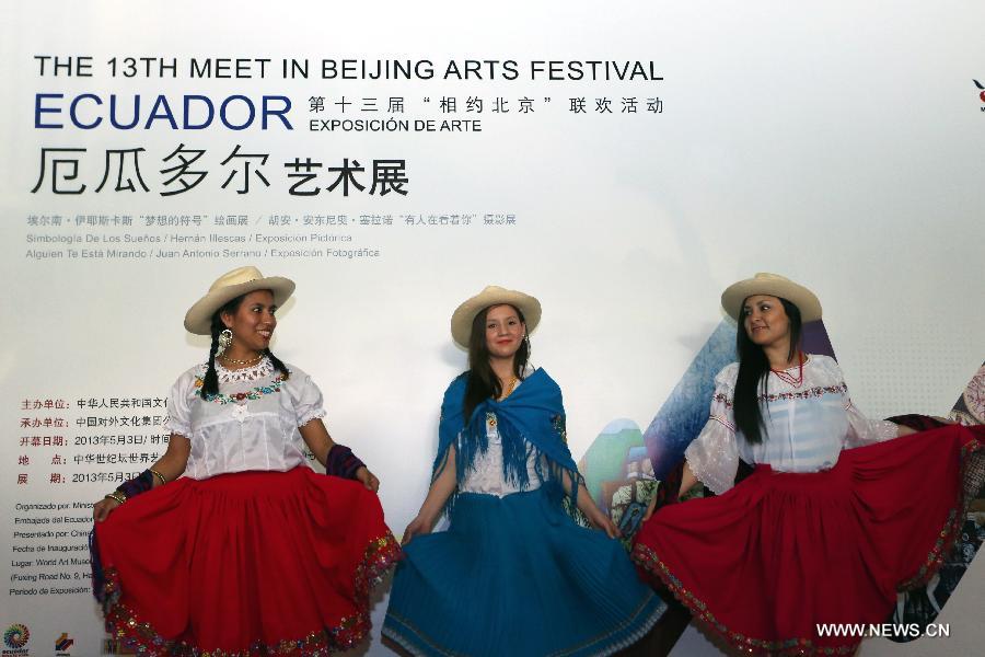 Actresses present Ecuadorian folk costumes at the Ecuador Art Exposition, an event of the 13th Meet in Beijing Arts Festival in Beijing, capital of China, May 3, 2013. A total of 83 works will be displayed at the exposition that kicked off on Friday. (Xinhua/Pan Siwei)