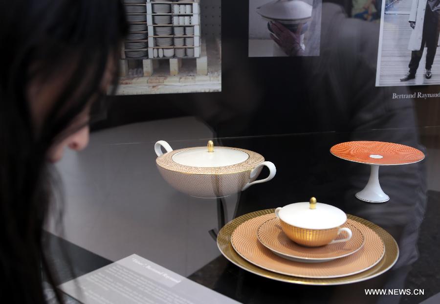 A visitor looks at a set of tableware during an exhibition of "Splendour of the French Table" in Hong Kong, south China, May 4, 2013. As one of the activities of "French May", the exhibition which will last till June 9 presents tableware from leading French historical manufactures and luxury maisons since the 18th century. (Xinhua/Li Peng) 