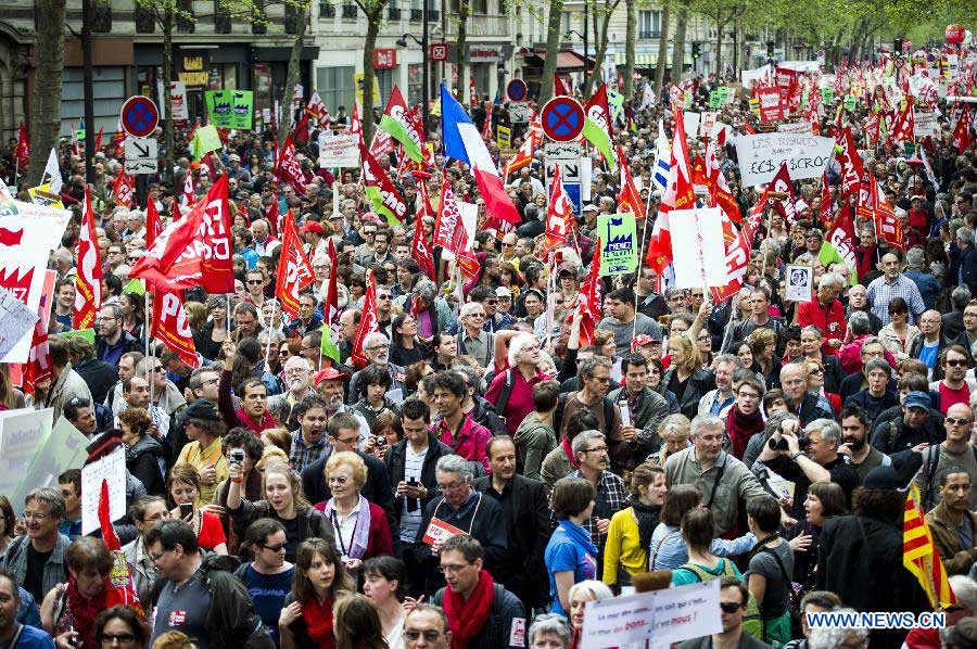 People participate in a demonstration in Paris, France, May 5, 2013. As the Socialists mark their first year in office, tens of thousands of protesters marched in towns across France on Sunday against president Francois Hollande's growth and job policy. (Xinhua/Etienne Laurent)
