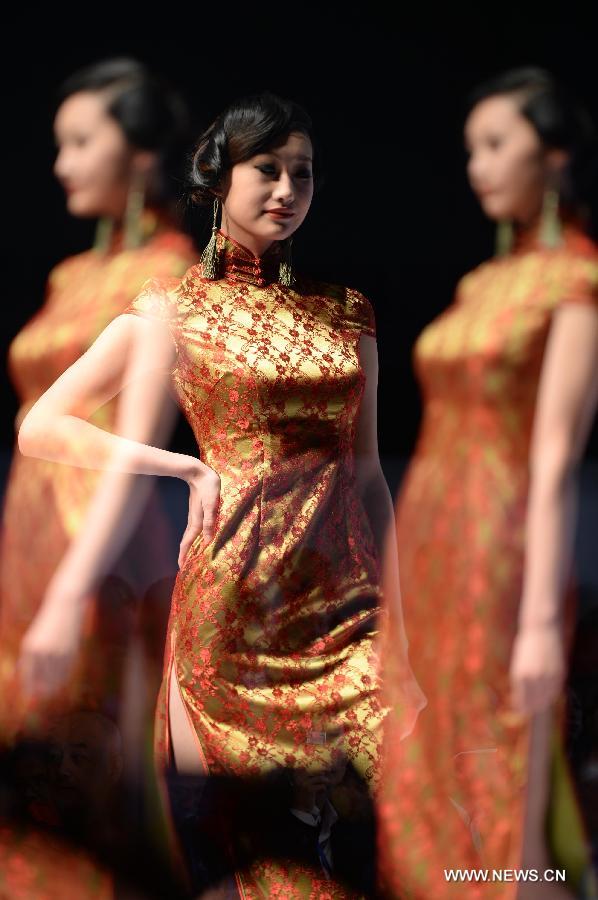 Photo taken on May 5 with multiple exposure camera settings shows a model presenting fashion creation designed by Gao Lixin during the 2013 China (Qingdao) International Fashion Week in Qingdao, a coastal city in east China's Shandong Province, May 5, 2013. (Xinhua/Li Ziheng)