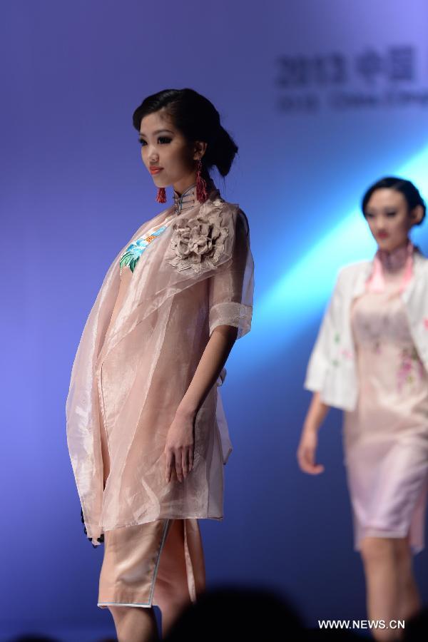 Models present fashion creations designed by Gao Lixin during the 2013 China (Qingdao) International Fashion Week in Qingdao, a coastal city in east China's Shandong Province, May 5, 2013. (Xinhua/Li Ziheng) 