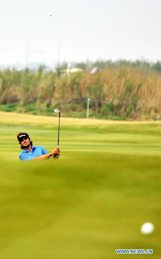 Victor Dubuisson of France hits a shot in the final round of the Volvo China Open at Tianjin Binhai Lake Golf Club in Tianjin, China, May 5, 2013. (Xinhua/Yue Yuewei)