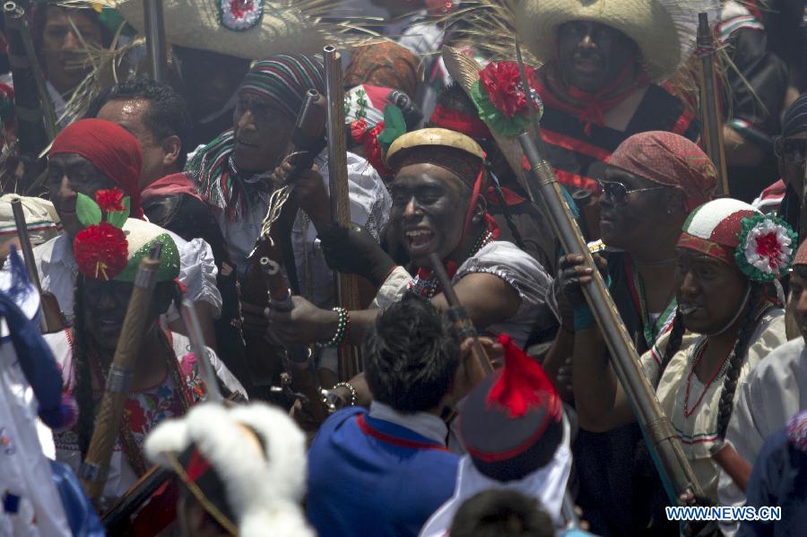 Residents participate in the celebrations of 151st anniversary of the Battle of Puebla, at the Penon de los Banos neighborhood, in Mexico City, capital of Mexico, on May 5, 2013. The Battle of Puebla took place on May 5 1862 near the city of Puebla during the French intervention in Mexico. The Mexican victory is celebrated yearly on May 5. (Xinhua/Alejandro Ayala) 