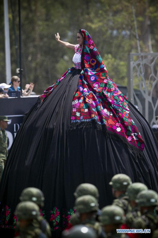 A woman participates in a parade during the celebrations of 151st anniversary of the Battle of Puebla, in the city of Puebla, Mexico, on May 5, 2013. The Battle of Puebla took place on May 5, 1862 near the city of Puebla during the French intervention in Mexico. The Mexican victory is celebrated yearly on May 5. (Xinhua/Rodrigo oropeza)