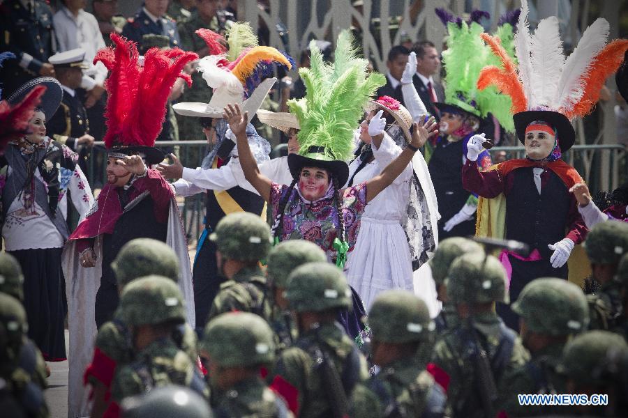 Residents dressed as "Huehues" participate in a parade during the celebrations of 151st anniversary of the Battle of Puebla, in the city of Puebla, Mexico, on May 5, 2013. The Battle of Puebla took place on May 5, 1862 near the city of Puebla during the French intervention in Mexico. The Mexican victory is celebrated yearly on May 5. (Xinhua/Rodrigo oropeza)