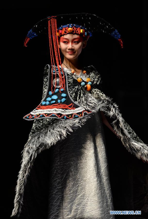 A model presents a traditional ethnic fashion creation during the 2013 China (Qingdao) International Fashion Week in Qingdao, a coastal city in east China's Shandong Province, May 5, 2013. (Xinhua/Li Ziheng) 