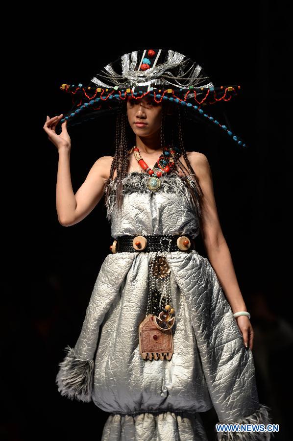 A model presents a traditional ethnic fashion creation during the 2013 China (Qingdao) International Fashion Week in Qingdao, a coastal city in east China's Shandong Province, May 5, 2013. (Xinhua/Li Ziheng) 