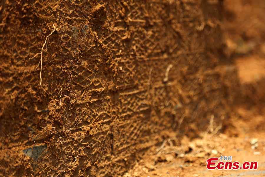 Bricks with patterns are found in an ancient tomb dating back to the Eastern Han Dynasty (25 AD-220 AD) in Gongqingcheng, Jiangxi Province, May 6, 2013. Burial objects including pieces of pottery and ironware were discovered in the tomb.(CNS/Liu Zhijian)