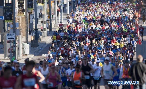 Participants run during the 35th Annual Toronto Marathon in Toronto, Canada, May 5, 2013. About 12,000 runners from over 50 countries and regions participated in the Marathon, Half Marathon, 5K or Relay on Sunday. (Xinhua/Zou Zheng) 