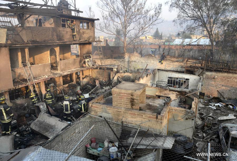 Firemen inspect the site of an explosion on the Mexico-Pachuca highway in Ecatepec, Mexico, on May 7, 2013. At least 20 people were killed and 34 injured when a gas tanker exploded early Tuesday in a Mexico City suburb, security officials said. (Xinhua/Susana Martinez) 