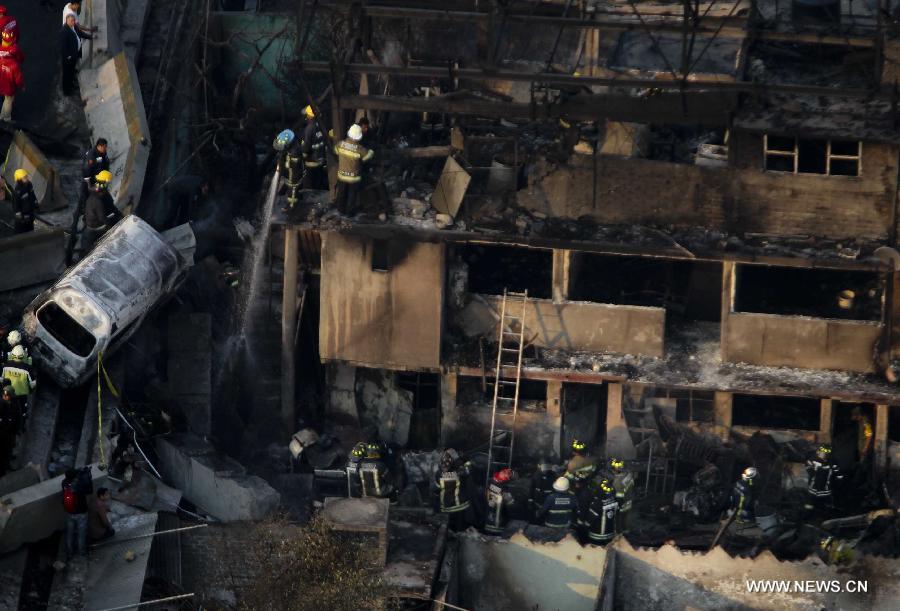 Firemen and Police work at the site of an explosion on the Mexico-Pachuca highway in Ecatepec, Mexico, on May 7, 2013. At least 18 people were killed and dozens of others injured when a gas tanker exploded early Tuesday in a Mexico City suburb, authorities said. (Xinhua/Susana Martinez) 