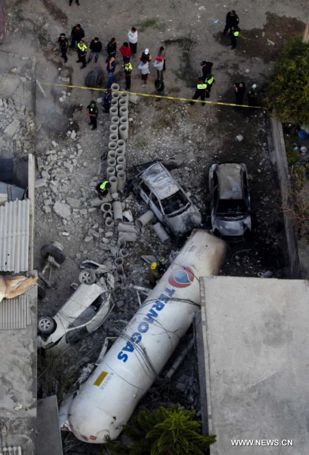Firemen and Police work at the site of an explosion on the Mexico-Pachuca highway in Ecatepec, Mexico, on May 7, 2013. At least 18 people were killed and dozens of others injured when a gas tanker exploded early Tuesday in a Mexico City suburb, authorities said. (Xinhua/Susana Martinez) 