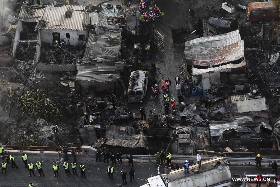 Firemen and Police work at the site of an explosion on the Mexico-Pachuca highway in Ecatepec, Mexico, on May 7, 2013. At least 18 people were killed and dozens of others injured when a gas tanker exploded early Tuesday in a Mexico City suburb, authorities said. (Xinhua/Susana Martinez) 