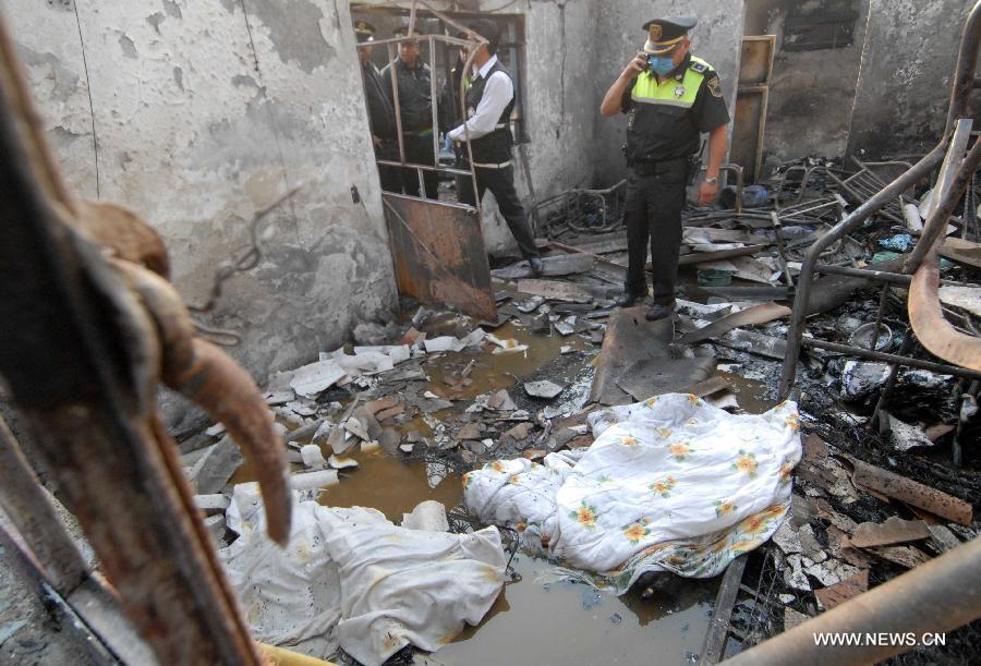 Firemen inspect the site of an explosion on the Mexico-Pachuca highway in Ecatepec, Mexico, on May 7, 2013. At least 20 people were killed and 34 injured when a gas tanker exploded early Tuesday in a Mexico City suburb, security officials said. (Xinhua/Susana Martinez) 